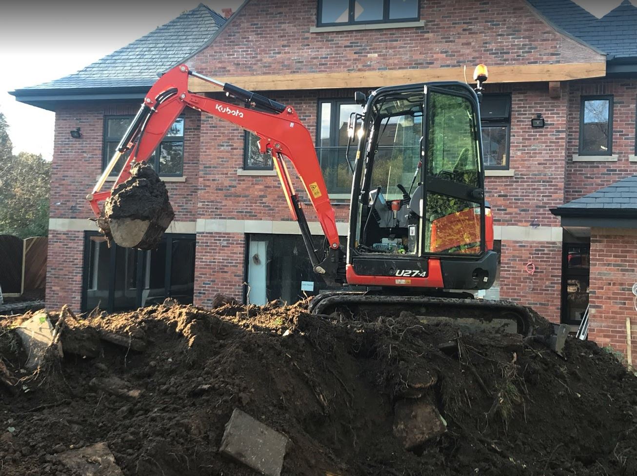 Professional excavation contractor using modern excavator on Manchester construction site