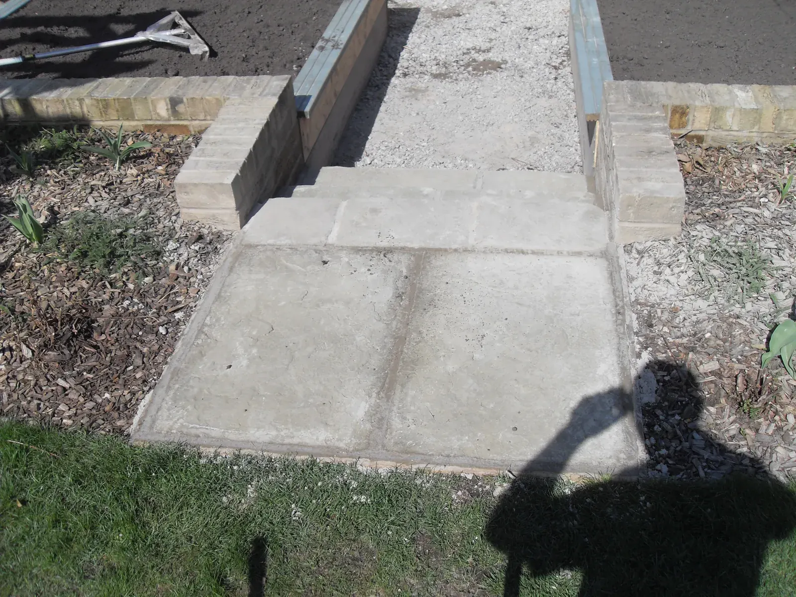 Concrete path and step laid across a domestic garden