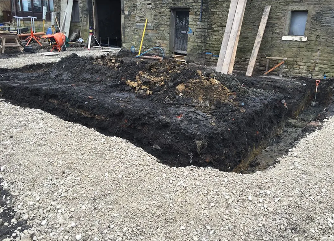 Excavated and stone filled base laid over membrane ready for surfacing