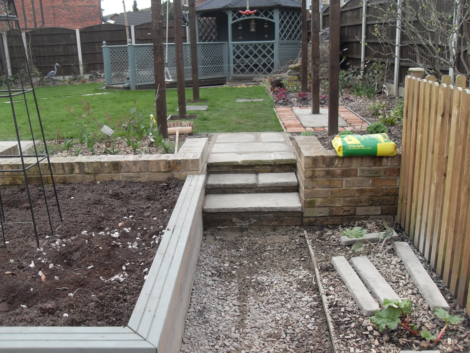 Garden landscaped with sleeper raised beds and paved steps