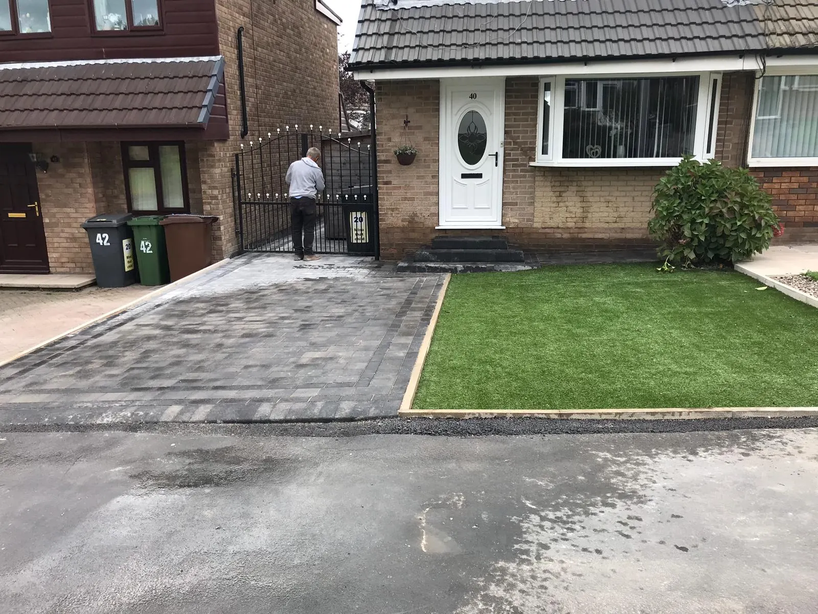Grey block paved driveway and lawn at a semi-detached house