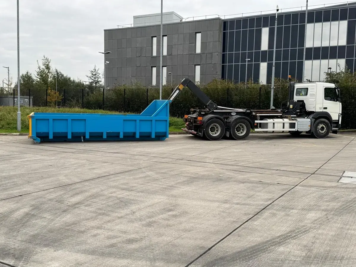 Hook-lift skip lorry parked on a finished commercial concrete hardstanding