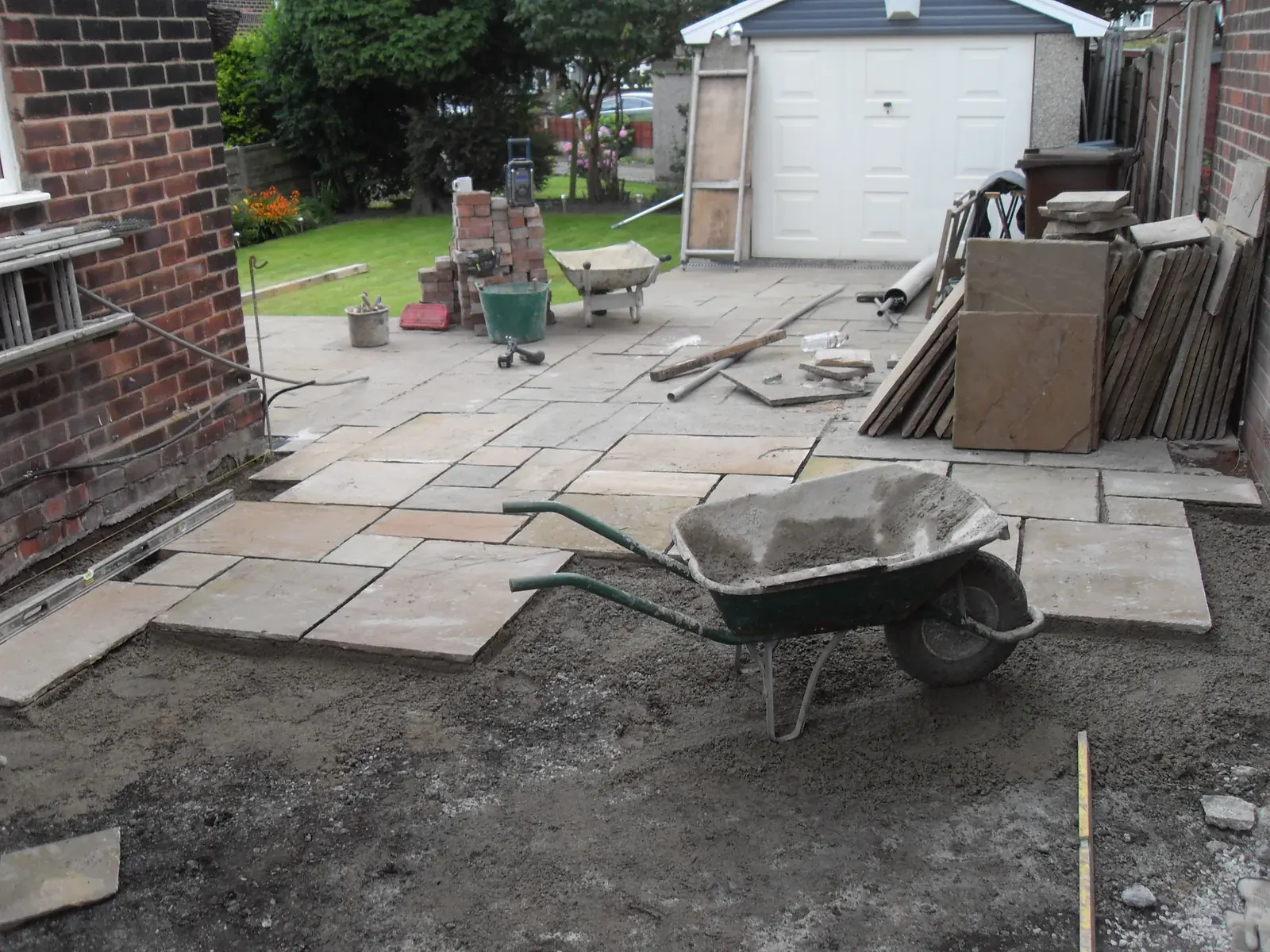 Indian sandstone patio being laid in a domestic rear garden