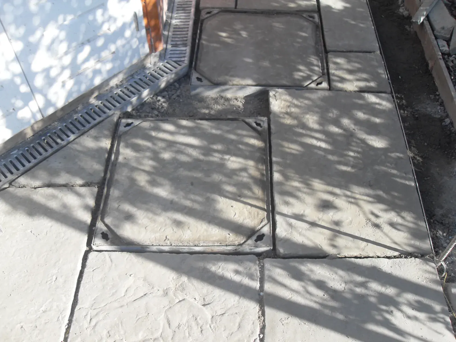 Large paved and concrete garden area laid to falls