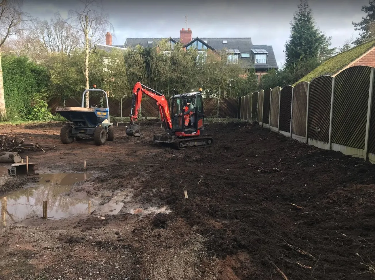 Mini excavator and dumper clearing a long rear garden