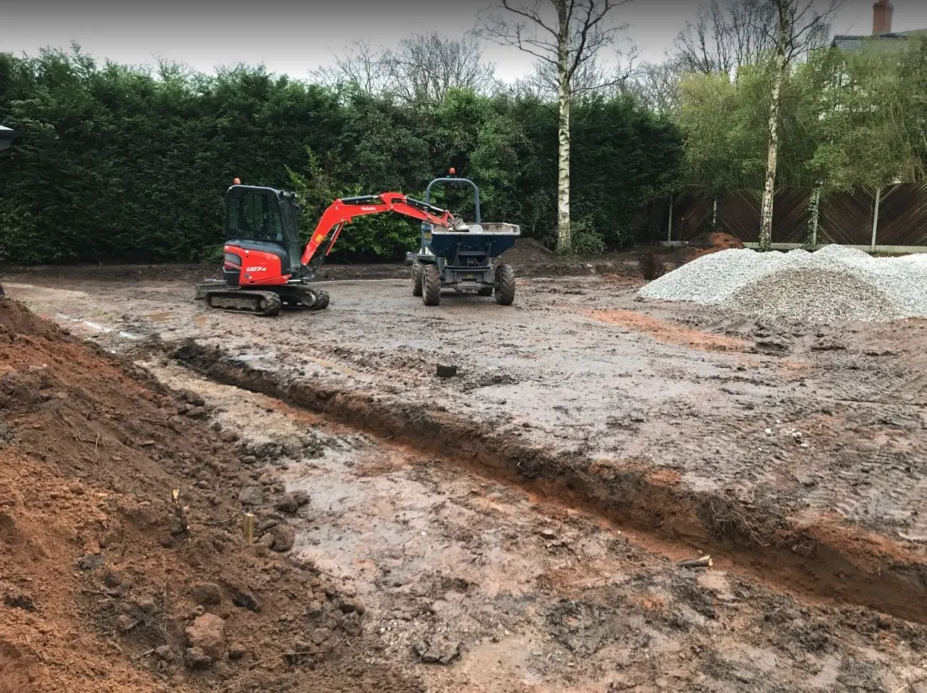 Mini excavator and dumper stripping a large plot ready for groundwork