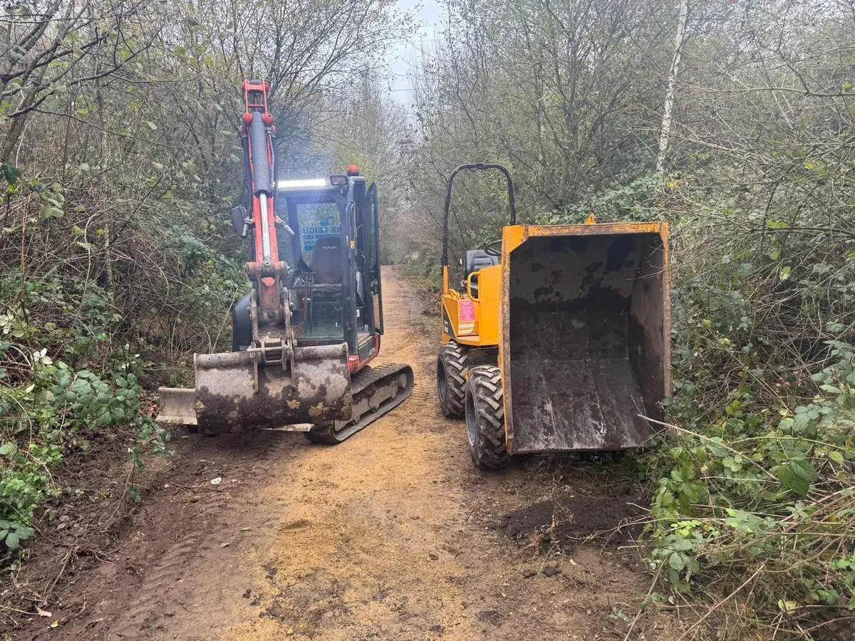 Mini excavator and tracked dumper moving soil on a groundwork site