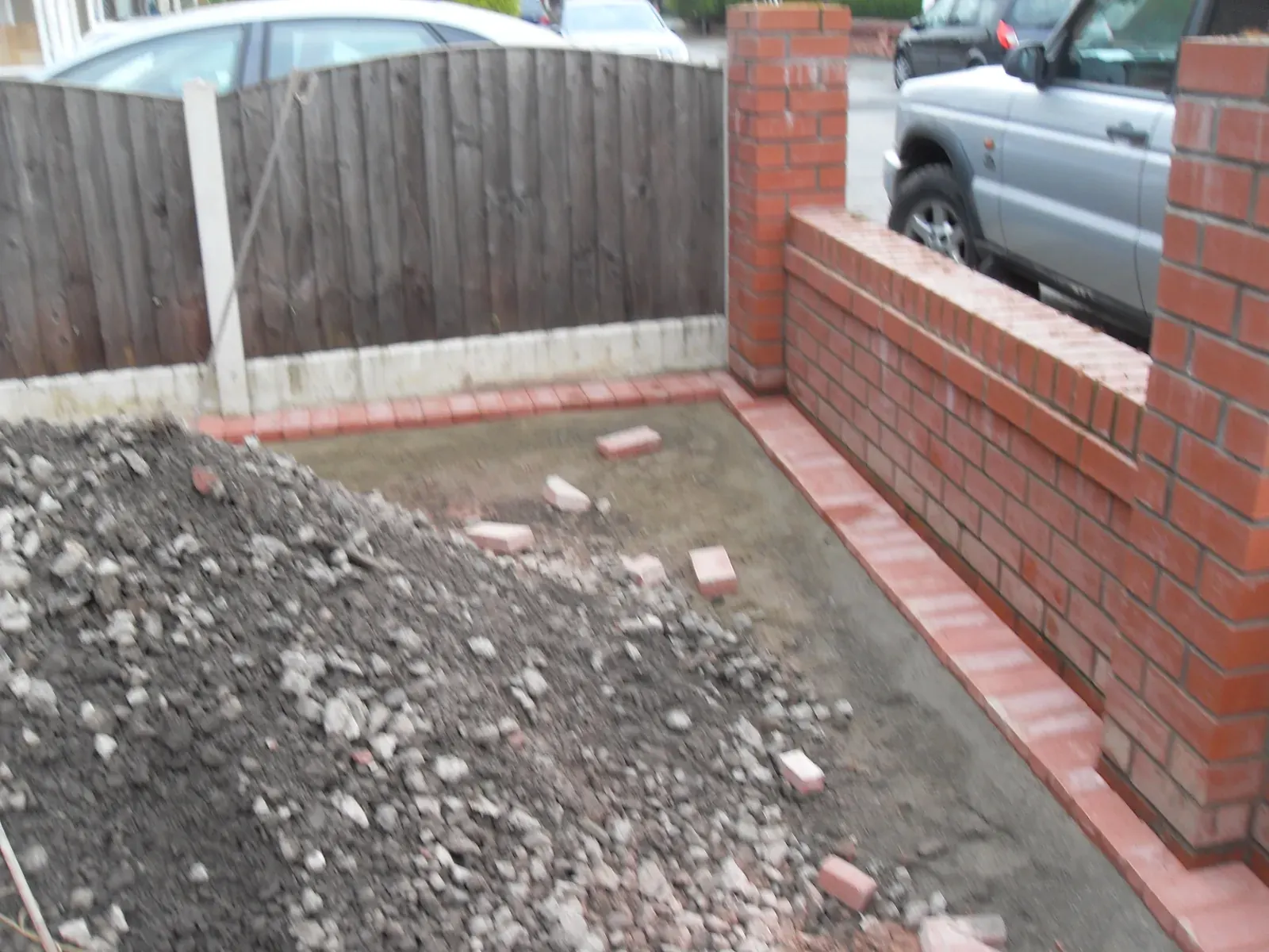 New red brick front garden wall with ground cleared behind