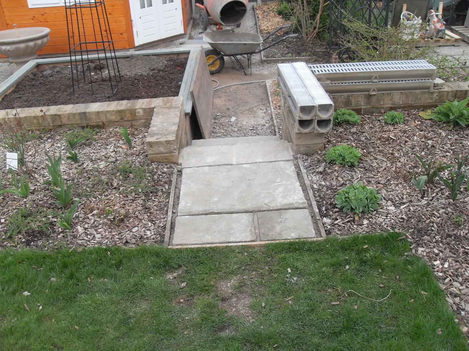 New slab path laid between raised beds in a rear garden