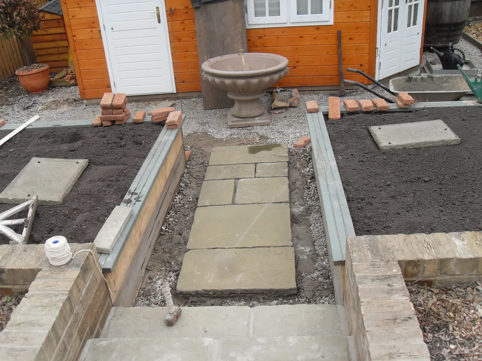 Paved garden with ornamental stone urn as a centrepiece