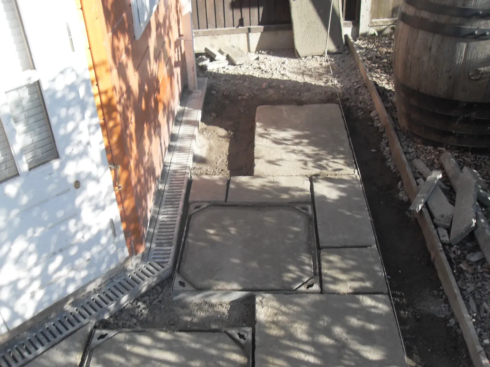 Paving slabs laid around timber pergola posts