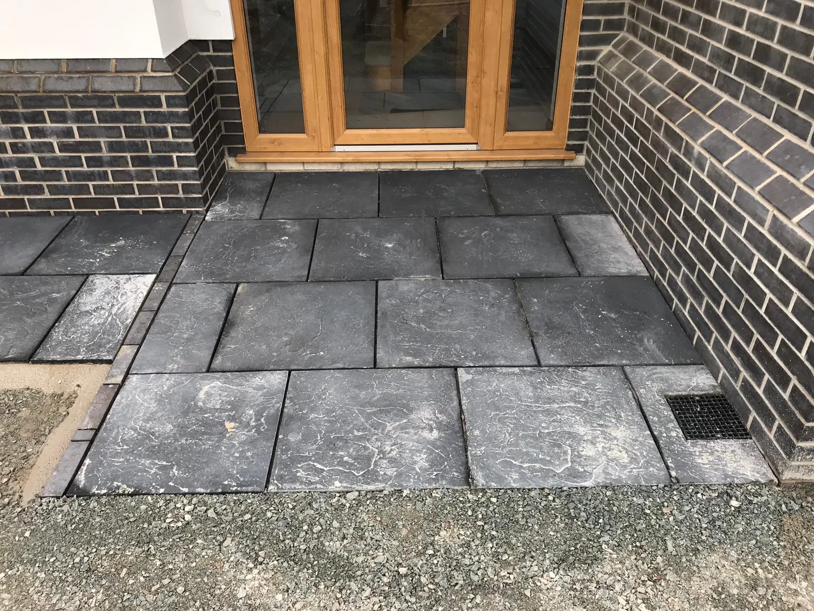 Slate patio laid outside timber French doors