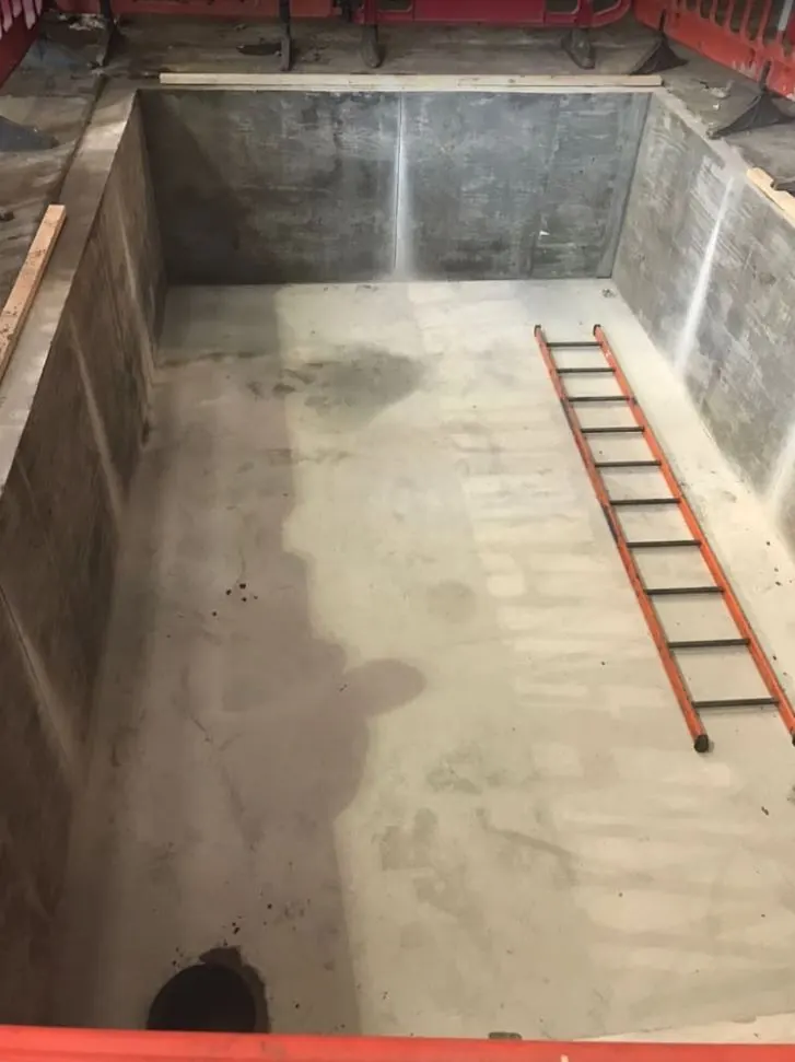 Swimming pool excavation in a back garden, ready for the pool shell