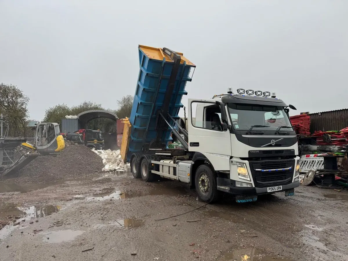 Tipper lorry tipping excavated material at the yard