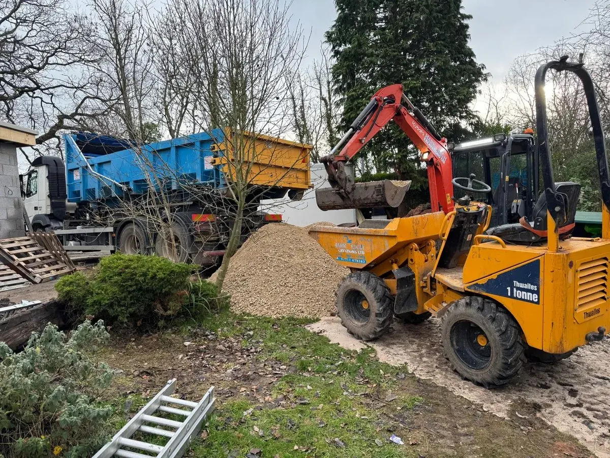 Tracked dumper and mini excavator working in a domestic rear garden